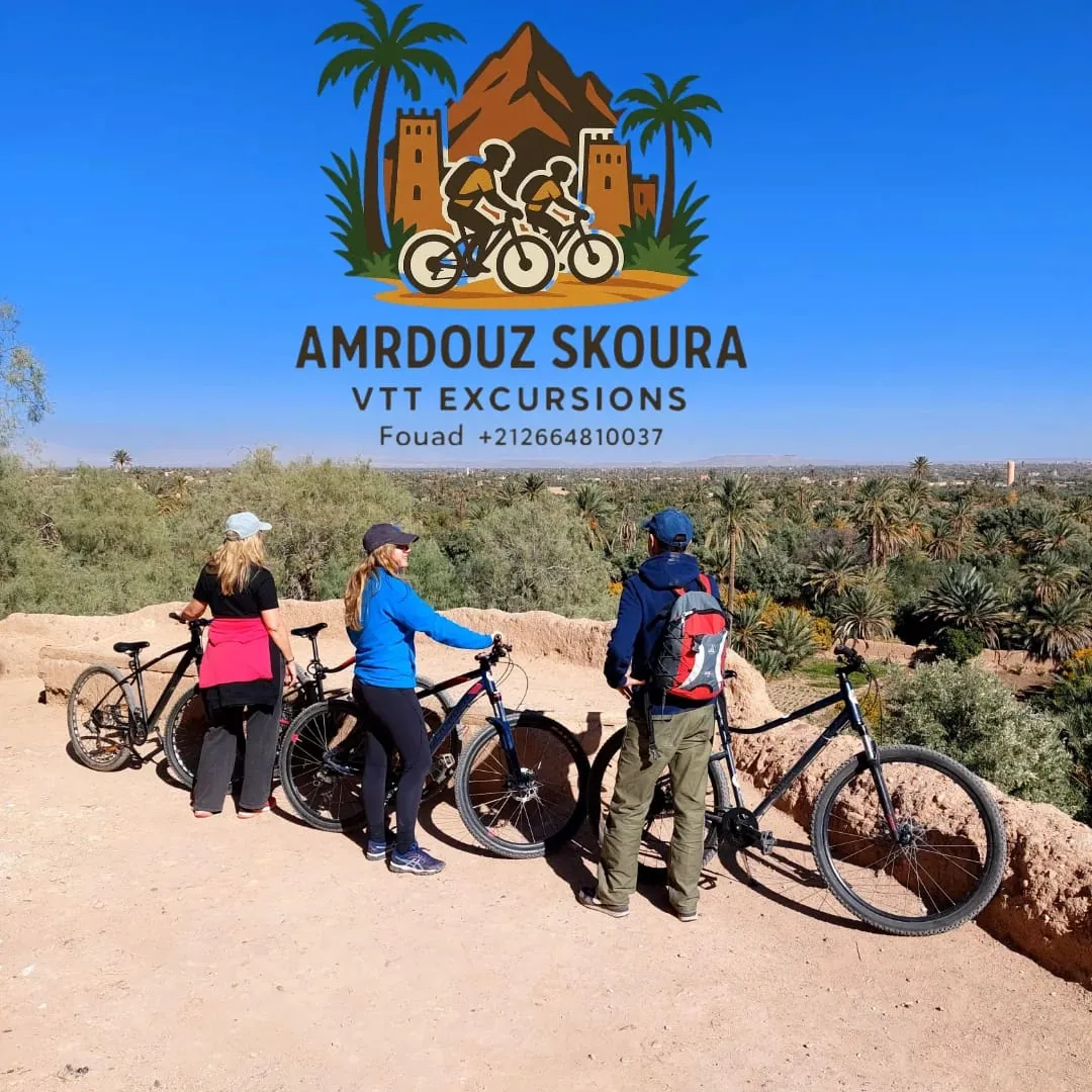 Guests and a local guide pausing with bicycles on a Skoura Oasis trail